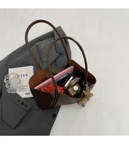 Internal view of the brown leather tote bag showing large capacity and soft texture