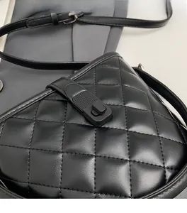 Close-up of black quilted crossbody bag showing premium faux leather texture and stitching