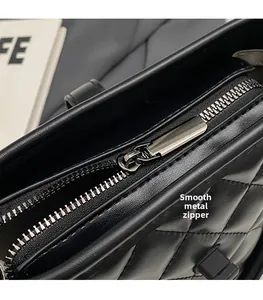 Detail of premium black quilted leather bag showing smooth metal zipper and hardware