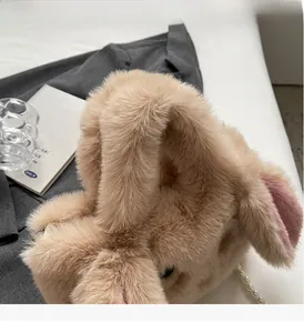 Detail of plush khaki tote bag featuring rabbit ears and elegant pearl chain handle