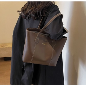 Close-up of brown tote bag with white contrast stitching and Fashion & Bags text logo