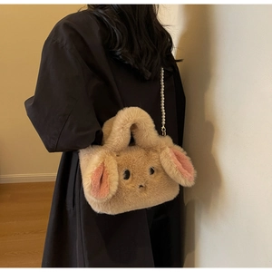 Detail of plush rabbit bag with soft khaki faux fur and elegant pearl strap