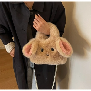Detail of soft plush rabbit crossbody bag featuring a pink ear and pearl chain strap