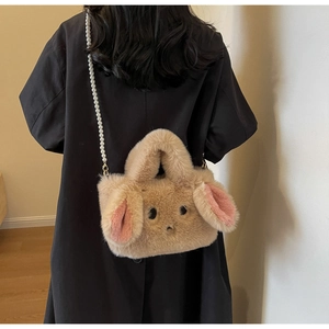 Detail of plush rabbit crossbody bag featuring faux pearl strap and soft beige fur texture