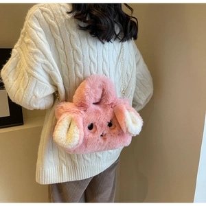 Detailed back view of a plush pink rabbit bag with white long ears and pearl strap