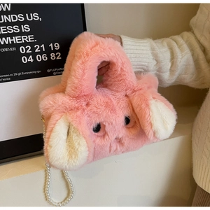 Detail of pink plush bunny bag with soft faux fur texture and pearl beaded chain strap