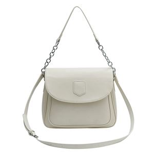 Cream retro underarm crossbody bag with silver chain and flap shield detail