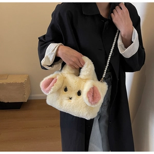 Detailed close-up of plush rabbit bag with soft faux fur and elegant pearl chain strap