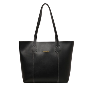 Classic black leather tote bag for women with contrast white stitching and gold lettering