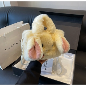 Detail showing plush rabbit bag with soft faux fur texture and elegant pearl strap