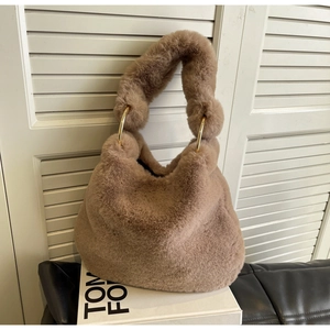 Close-up of fluffy mocha brown faux fur bag featuring stylish gold metal ring connectors