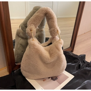 Detail of plush faux fur tote bag with soft texture and gold metal ring handles