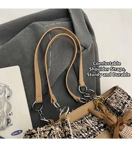 Detail of tweed tote bag showing leather handles and cute rabbit charm ornament