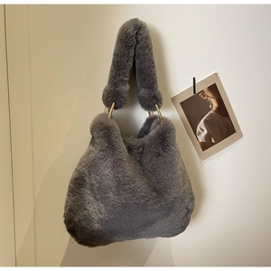 Detail of soft dark grey faux fur shoulder bag with decorative gold metal ring connectors