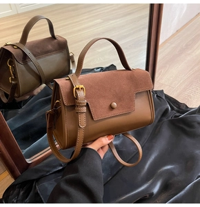 Detail of the brown crossbody bag with matte suede texture and smooth leather finish