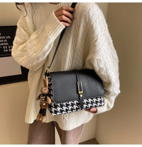 Detail of crossbody tote bag with houndstooth pattern and cute brown rabbit charm
