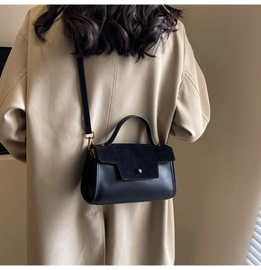 Minimalist black leather and suede crossbody bag shown on model for a premium look