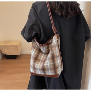 Detailansicht der Vintage Karotasche mit braunem Lederbesatz und geknoteten Trägern
