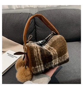 Brown fuzzy plaid Boston bag detail with plush poms and brown fabric handles