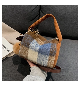 Detail of Boston plaid plush handbag with autumn winter faux fur texture and pompom