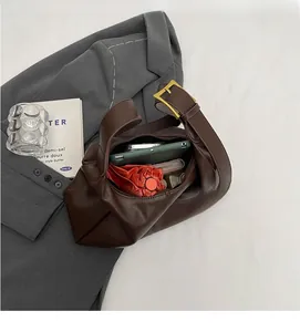 Detailed interior of dark brown hobo bag showing large capacity and zipper pocket