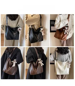 Detailed views of high-capacity tote bag in black, brown and cream with bear pendant