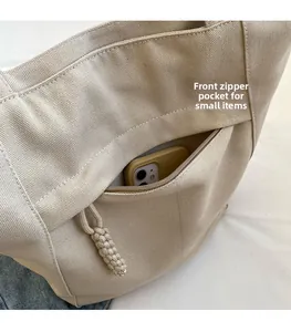 Bolsillo delantero con cremallera del bolso tote de lona beige con espacio para móvil