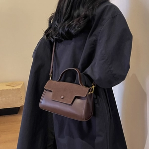 Elegant dark brown leather crossbody bag with suede patchwork and gold-tone hardware