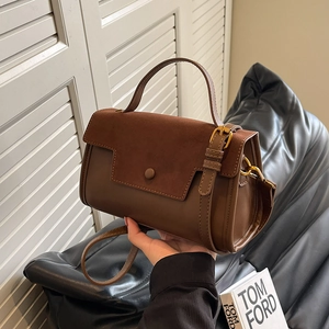 Chic brown leather crossbody bag with suede flap shown in a high-end lifestyle setting