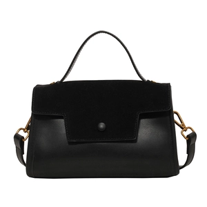 Minimalist black leather crossbody bag with mixed textures and vintage round buckle