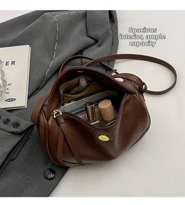 Top view of deep brown leather crossbody bag showing large capacity and inner pockets