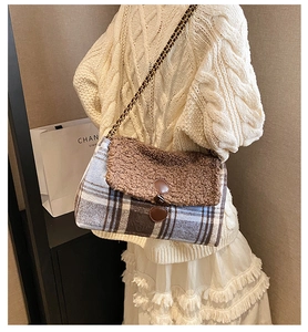 Detail of plaid tote bag with faux shearling flap and metal chain strap on model