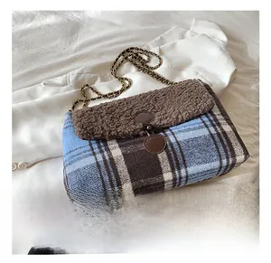 Detailed view of the plaid fabric texture and fuzzy shearling flap on the tote bag