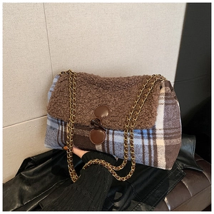 Close-up of contrast patchwork tote bag with teddy fur cover and metal chain strap