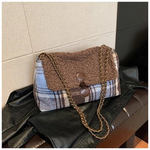 Detail of checkered tote bag featuring brown faux shearling and gold chain strap
