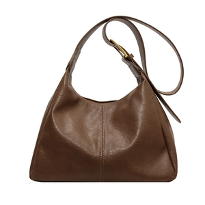 Minimalist brown leather tote bag with vertical stitching and gold buckle details