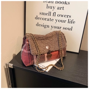 Close-up of retro plaid tote bag with brown sherpa trim and golden chain strap