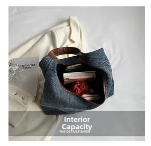 Internal capacity of denim tote bag showing space for phone, notebook and wallet