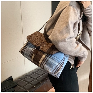 Detail of a brown fuzzy sherpa and plaid tweed shoulder bag with gold chain strap