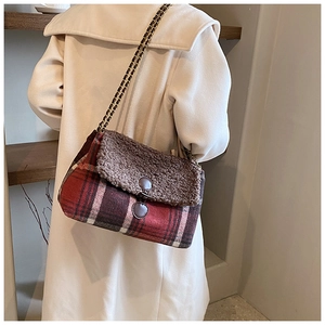 Detail of a retro plaid tote bag with faux shearling trim and woven chain strap