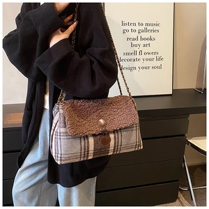 Detailed close-up of brown sherpa and plaid fabric textures on this stylish tote bag