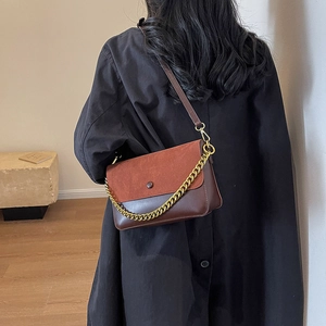Retro patchwork crossbody bag in dark brown and brick red leather with gold chain detail
