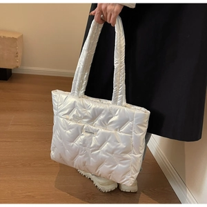 Detail of white quilted tote bag in waterproof nylon with diamond stitching pattern