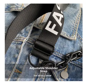 Detailed macro view of adjustable black canvas strap with letters and plastic chain decoration