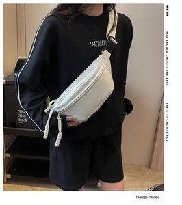 Detailed shot of cream leather fanny pack with braided zipper and quick-release buckle