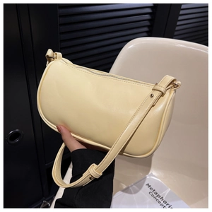 Close-up of cream PU leather baguette bag with silver zipper and adjustable strap