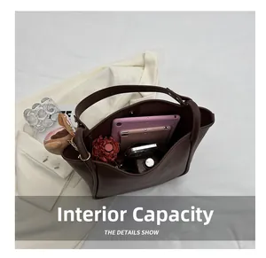 Interior detail of large capacity brown tote bag showing organized daily essentials