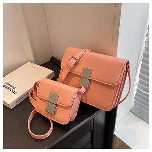 Detail of pink leather flap bags in two sizes with vertical silver metallic buckles