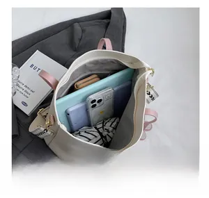 Top view of large beige tote bag interior showing capacity for tablet, phone, and umbrella