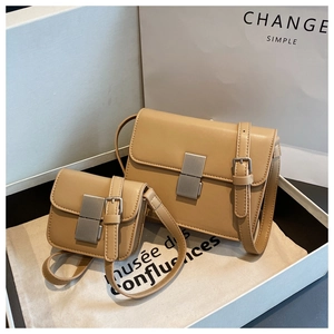Unboxing detail of khaki leather crossbody square bags with silver metal buckle in a gift box